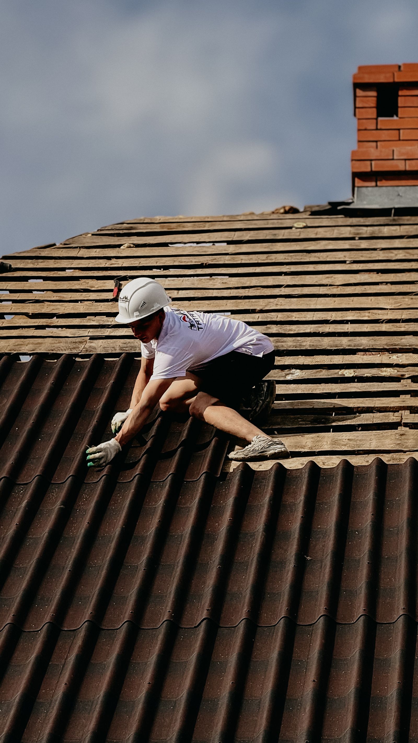 Roofer working safely on a residential roof